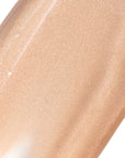 Close-up of a beige cosmetic product with a glossy finish on a white background