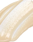 Close-up of a smooth, beige-colored cream swatch on a white background