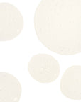 Five white circular objects on a light beige background