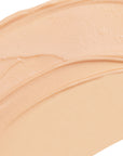 Close-up of beige makeup swatch on a white background