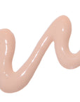 Close-up of DERMA E Vitamin C No Dark Circles Perfecting Eye Cream showing its smooth, peach-colored texture in a wavy line pattern.