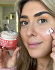 Woman holding a jar of Pure Biome Balancing Cream