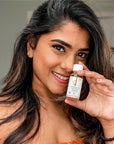 Woman holding a bottle of Derma E's Sulfur Spot Treatment