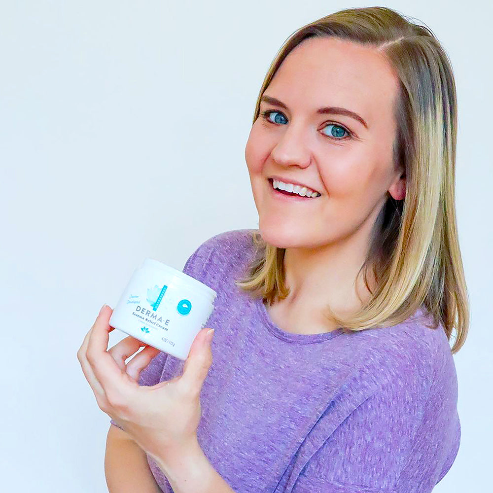 Woman holding a jar of Eczema Relief Cream