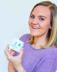 Woman holding a jar of Eczema Relief Cream