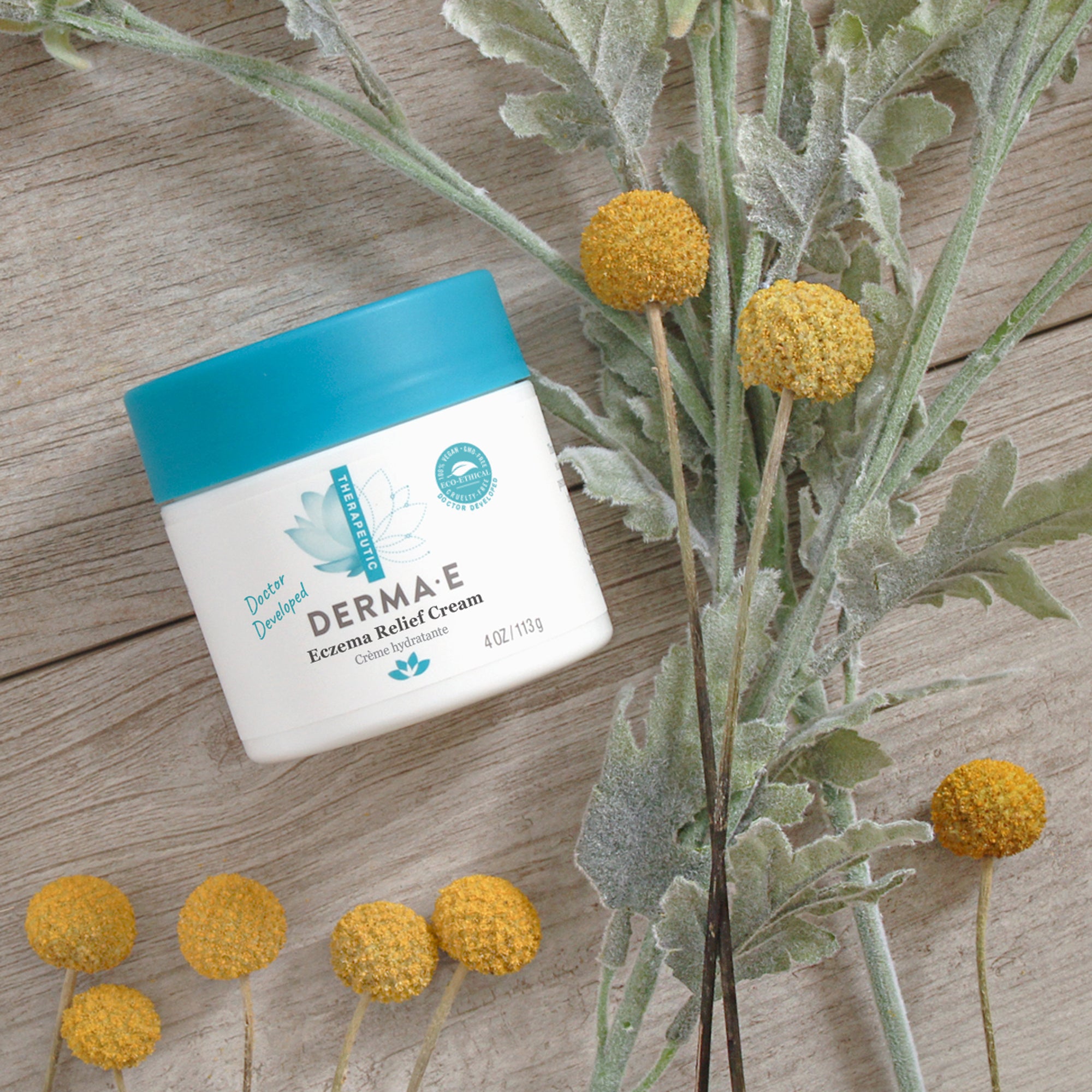 Jar of Eczema Relief Cream on a table with flowers
