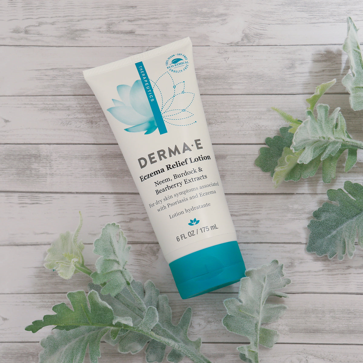 Flatlay of Eczema Relief Lotion bottle front - featuring key ingredients Neem, Burdock, and Bearberry extracts for relieving dry skin symptoms associated with psoriasis and eczema.