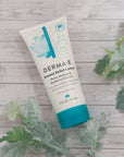 Flatlay of Eczema Relief Lotion bottle front - featuring key ingredients Neem, Burdock, and Bearberry extracts for relieving dry skin symptoms associated with psoriasis and eczema.