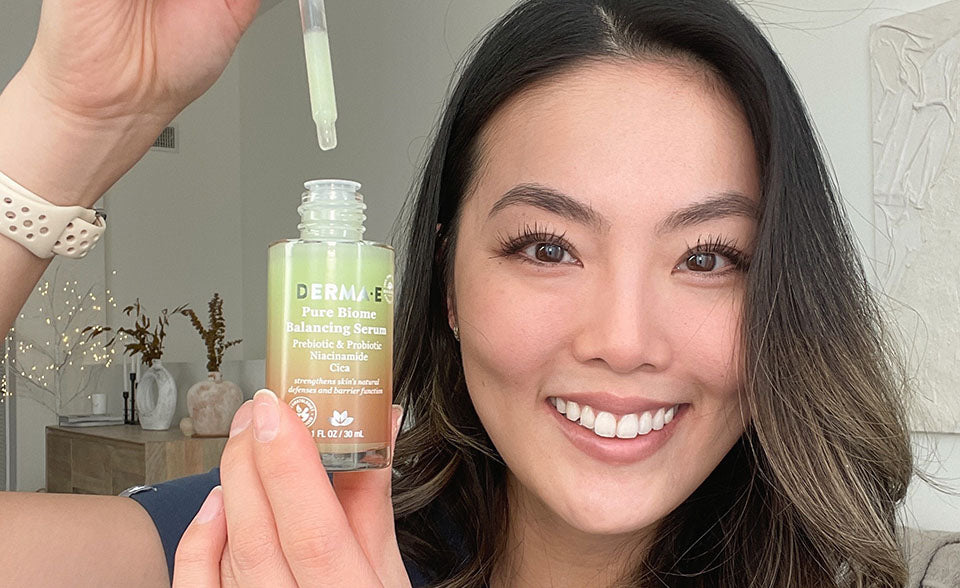 Dr. Kim holding a bottle of derma e pure biome balancing serum with niacinamide