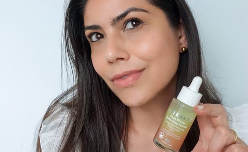 Girl holding a bottle of DERMA E Pure Biome Balancing Serum for fresh spring skin