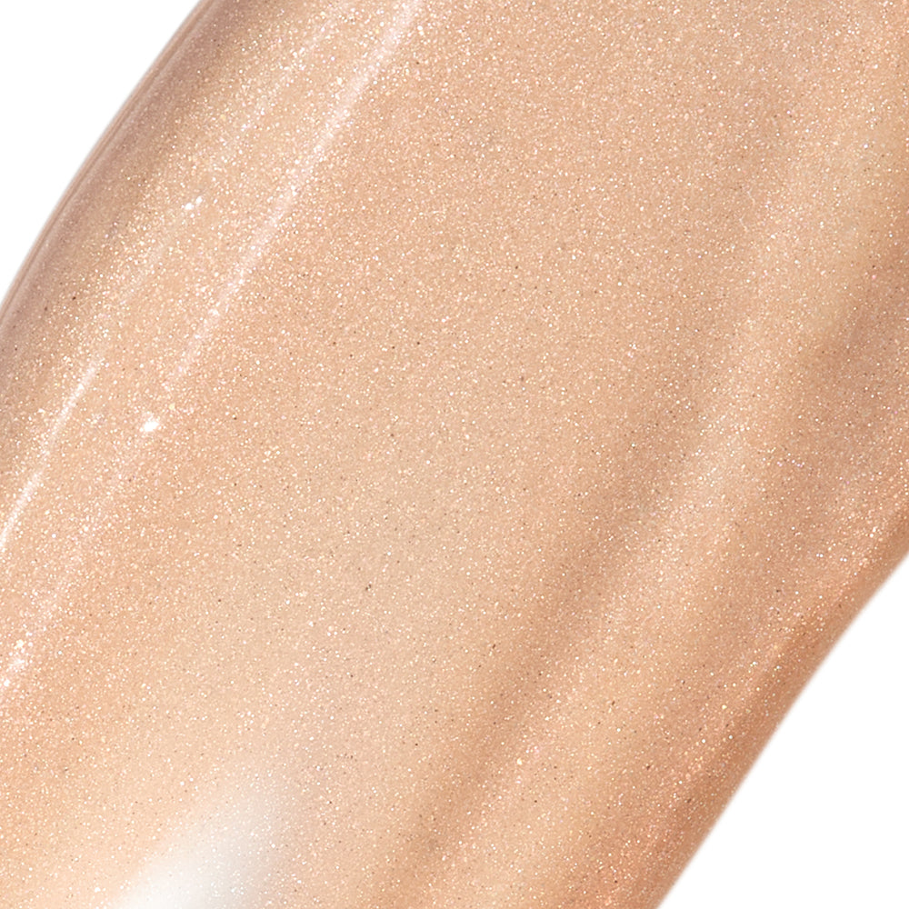 Close-up of a beige cosmetic product with a glossy finish on a white background