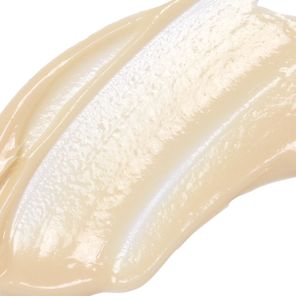Close-up of a smooth, beige-colored cream swatch on a white background