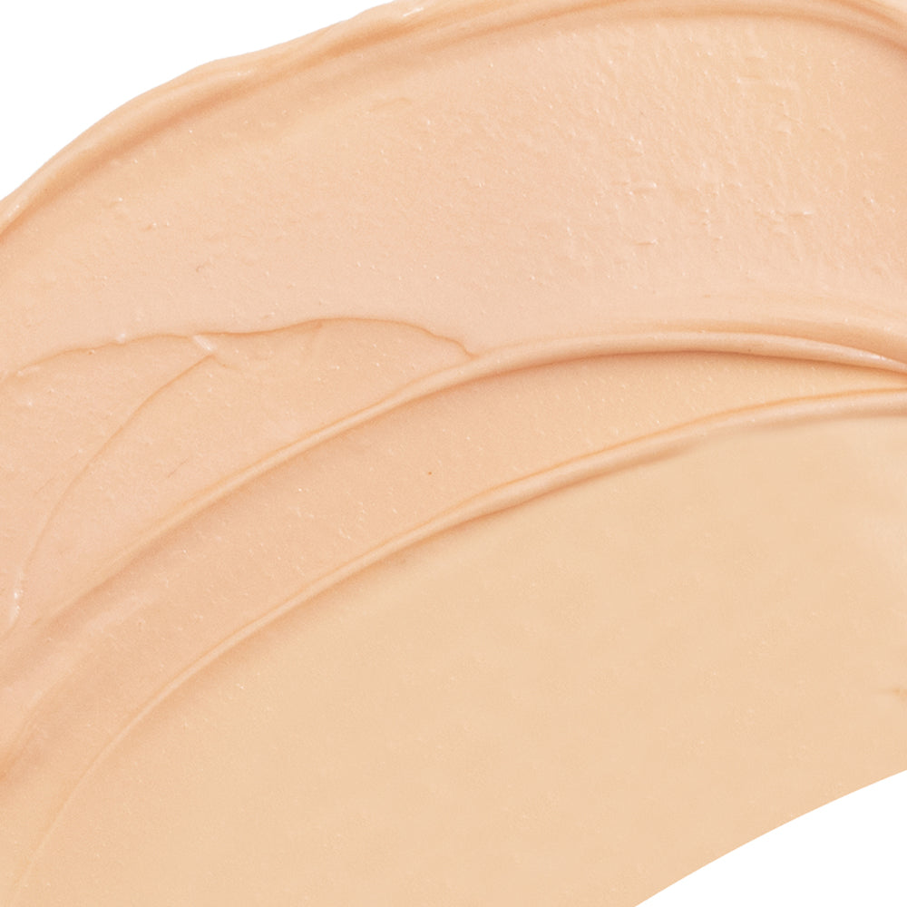 Close-up of beige makeup swatch on a white background