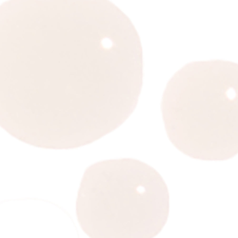 Close-up of three light pink pearls on a white background