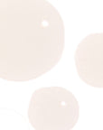 Close-up of three light pink pearls on a white background