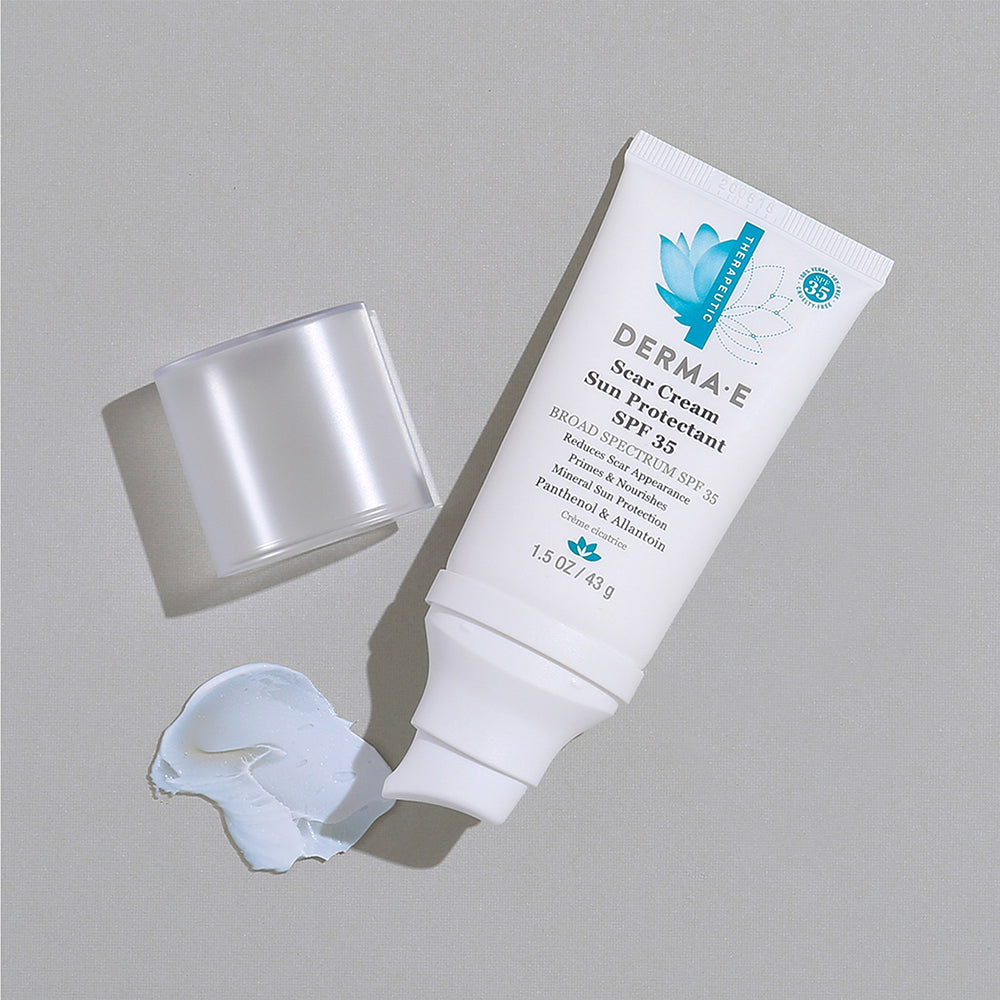 Open Bottle of Derma E Scar Cream Sun Protectant SPF 35 with product smear.