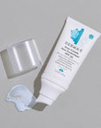 Open Bottle of Derma E Scar Cream Sun Protectant SPF 35 with product smear.