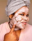 Woman using Vitamin C Gentle Daily Cleansing Paste as a face mask.