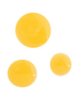 Close-up of three golden drops of Vitamin C product, highlighting its rich and nourishing texture.