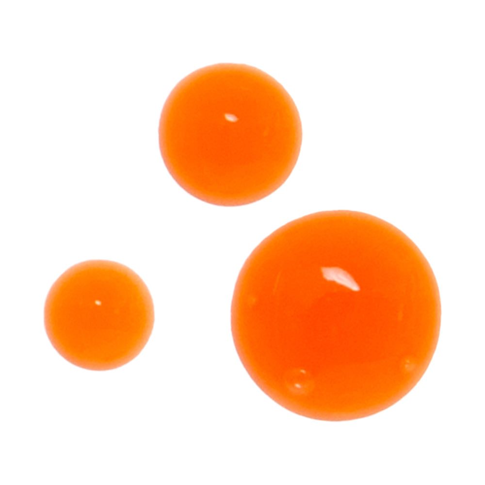 Close-up of three bright orange drops of Derma E Retinol product, showcasing its rich and effective formula.