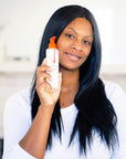 Woman holding a bottle of Anti-wrinkle cleanser