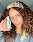 Woman holding a bottle of Vitamin E Oil for Skin - DERMA E Clean Skin Care