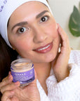 Woman applying Advanced Peptides & Flora-Collagen™ Night Moisturizer to her face, demonstrating its smooth, creamy texture and easy absorption.