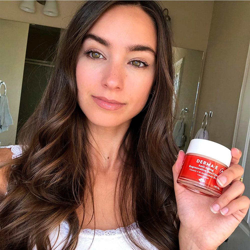 Woman holding a jar of Anti-Aging Regenerative Day Cream