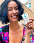 Woman holding a bottle of Derma E Scar Cream Sun Protectant SPF 35